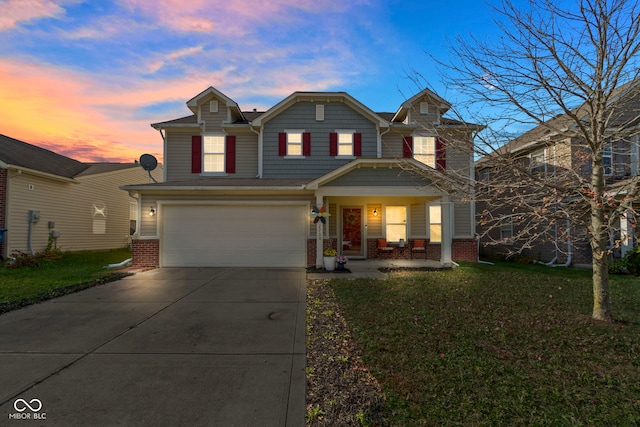 front of property featuring a yard and a garage