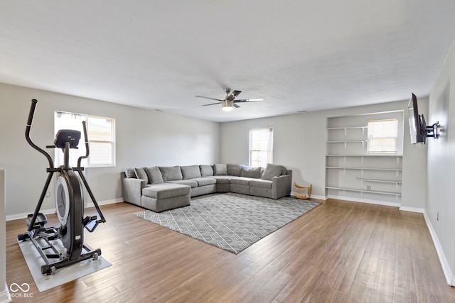 living room featuring ceiling fan, a healthy amount of sunlight, and hardwood / wood-style flooring