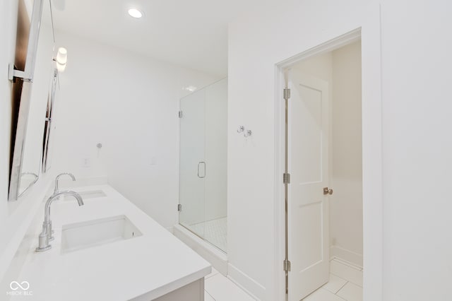 bathroom with vanity, a shower with door, and tile patterned floors