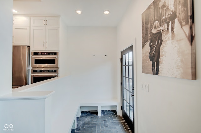 kitchen with appliances with stainless steel finishes and white cabinets