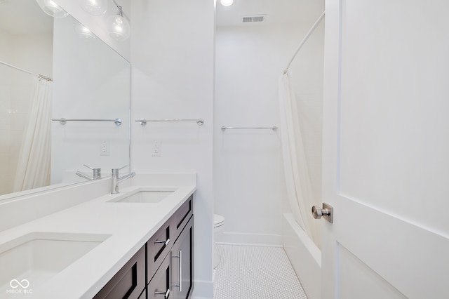 full bathroom with toilet, shower / tub combo, vanity, and tile patterned floors