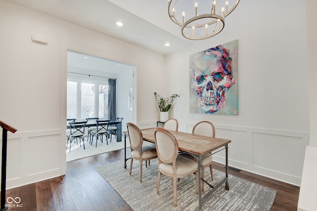 dining area featuring a notable chandelier and dark hardwood / wood-style floors