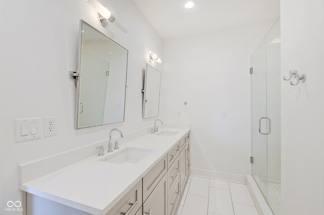 bathroom with vanity, a shower with door, and tile patterned flooring