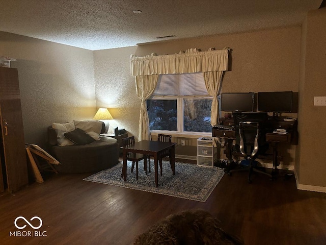 interior space with dark hardwood / wood-style floors and a textured ceiling