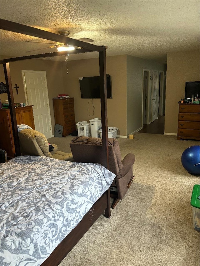 carpeted bedroom featuring a textured ceiling, ceiling fan, and baseboards