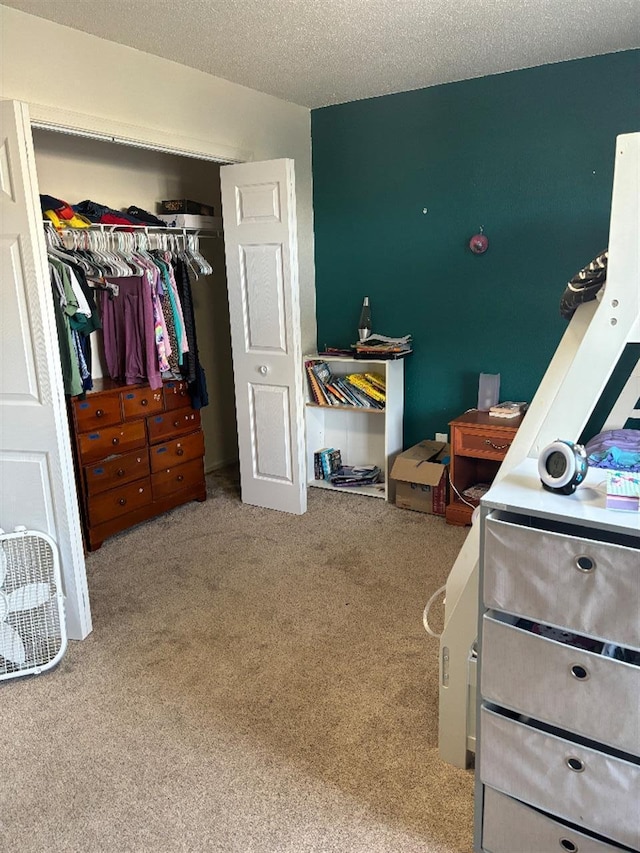 bedroom with carpet, a closet, and a textured ceiling