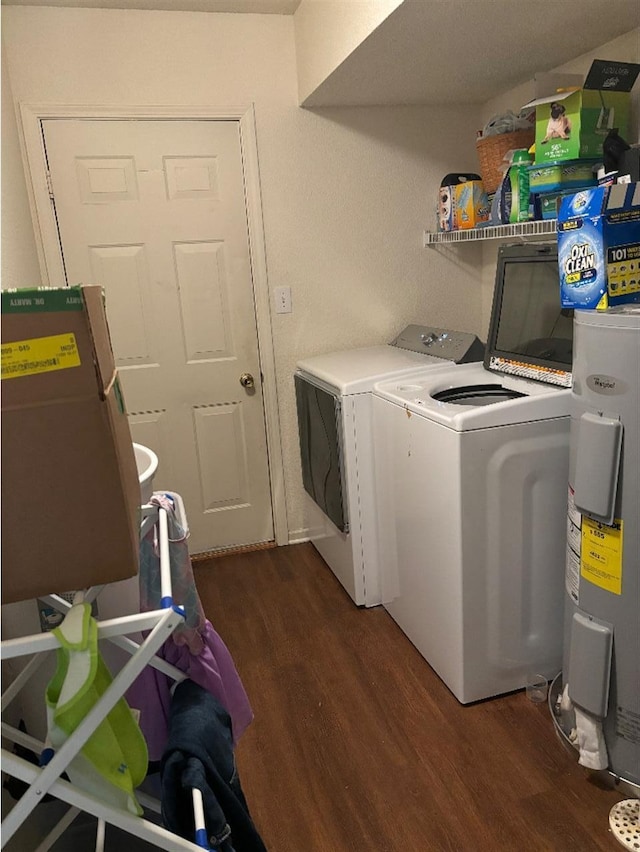 clothes washing area with laundry area, washer and clothes dryer, wood finished floors, and electric water heater