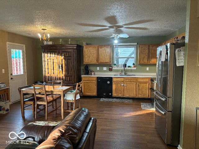 kitchen with black dishwasher, dark wood-style floors, freestanding refrigerator, light countertops, and a wealth of natural light