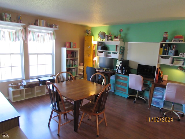dining space with wood finished floors, a desk, and a textured ceiling