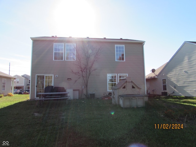 rear view of property with a yard