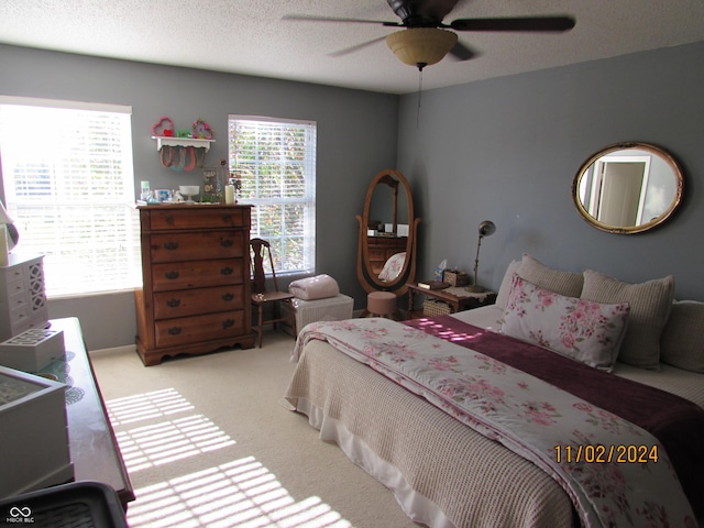carpeted bedroom with a ceiling fan