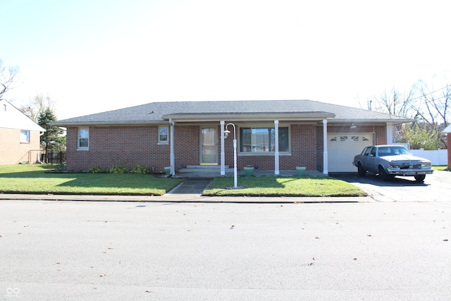 ranch-style house featuring a garage and a front yard