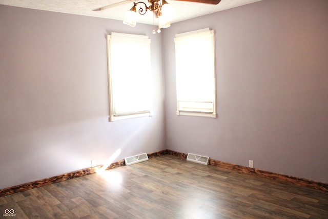 spare room with dark hardwood / wood-style flooring, a textured ceiling, and ceiling fan