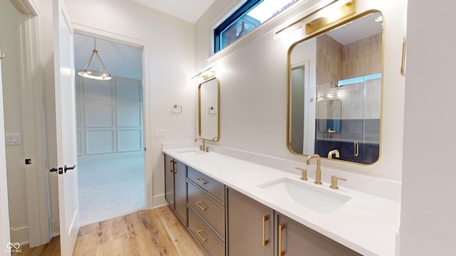 bathroom with wood-type flooring, walk in shower, and vanity