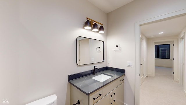 bathroom featuring toilet and vanity