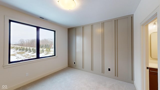 unfurnished bedroom featuring light colored carpet