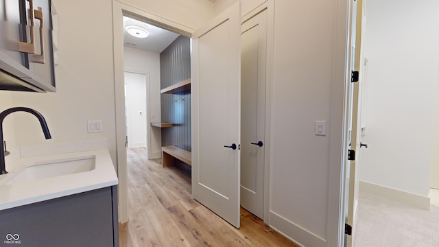 bathroom featuring vanity and hardwood / wood-style floors