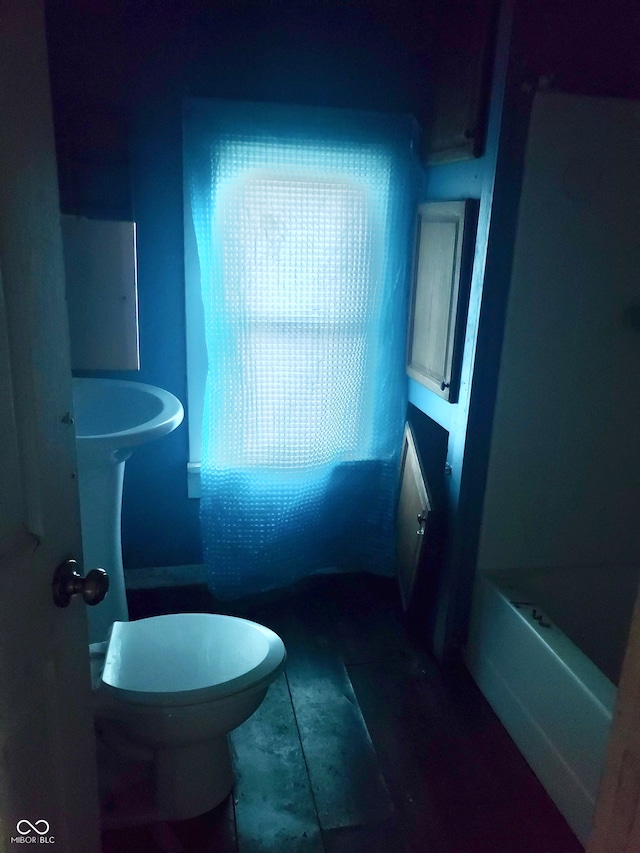 bathroom with tile patterned flooring, toilet, and a bathtub