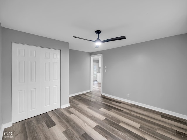 unfurnished bedroom featuring a closet, ceiling fan, and hardwood / wood-style floors