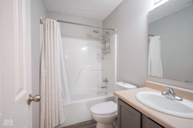 full bathroom with toilet, vanity, a textured ceiling, and shower / tub combo with curtain