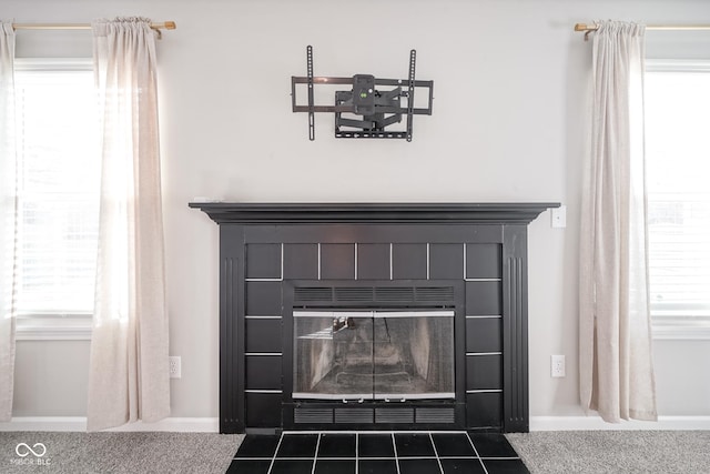 room details featuring a tile fireplace