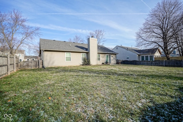 rear view of house with a yard