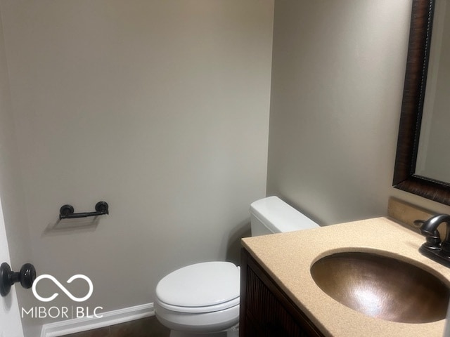 bathroom featuring toilet and vanity