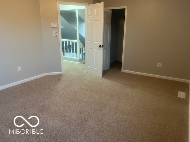 unfurnished room featuring carpet flooring