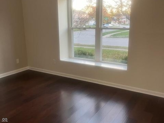 spare room featuring dark hardwood / wood-style flooring