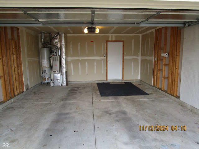 garage featuring water heater and a garage door opener