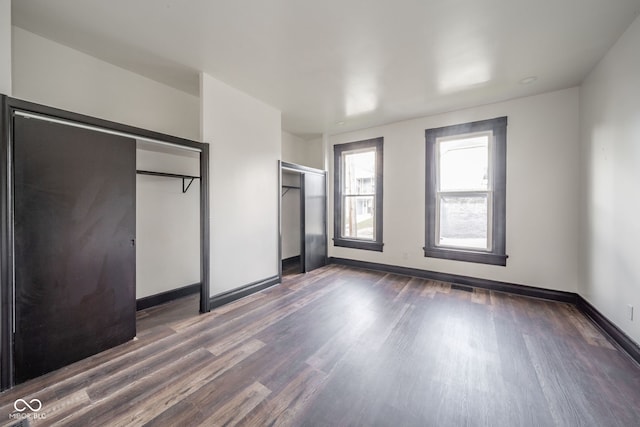 unfurnished bedroom featuring dark hardwood / wood-style floors