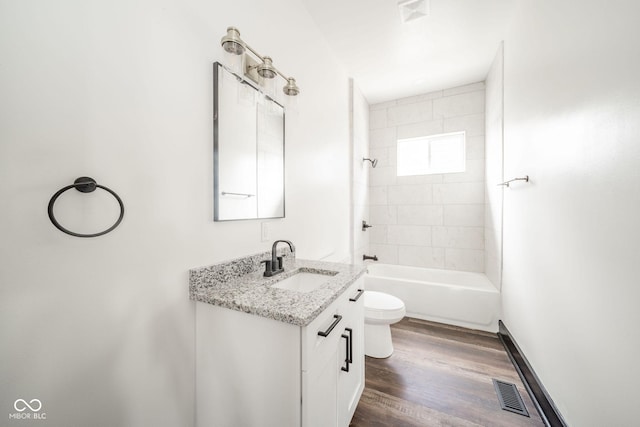 425 Sanders St, Indianapolis, IN 46225 - bathroom featuring toilet, vanity, wood finished floors, and shower / washtub combination
