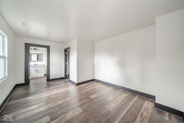 empty room with sink and dark hardwood / wood-style flooring