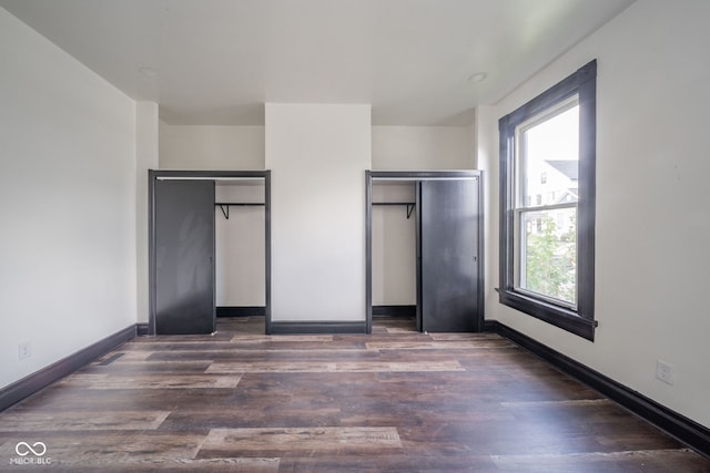 unfurnished bedroom featuring dark hardwood / wood-style floors