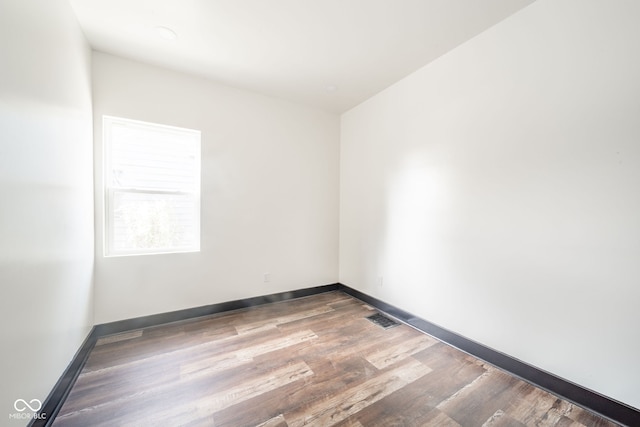 spare room with wood-type flooring