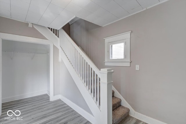 stairs featuring hardwood / wood-style floors