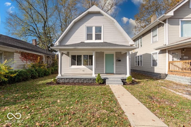 bungalow-style home featuring a porch and a front yard