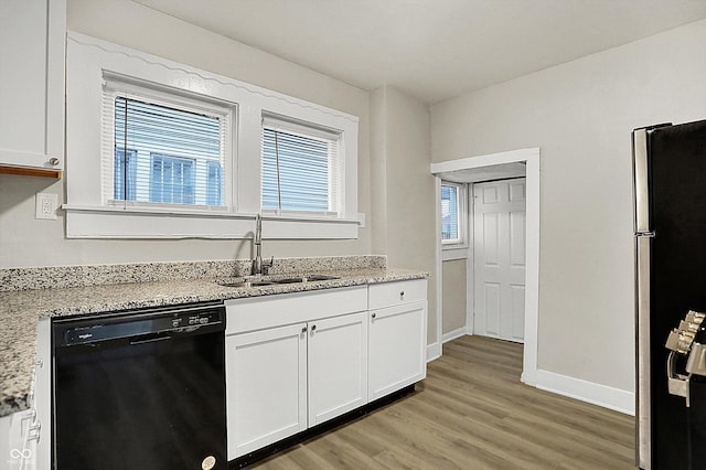 kitchen with white cabinets, dishwasher, sink, and stainless steel fridge