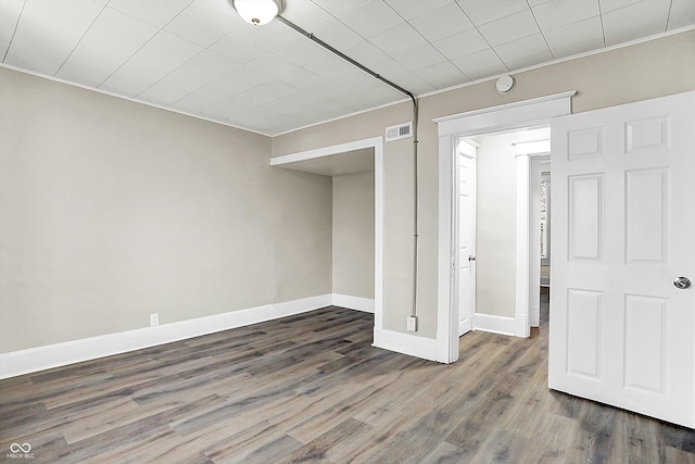 unfurnished room featuring ornamental molding and dark hardwood / wood-style floors