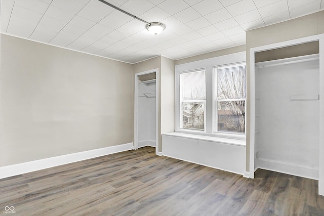 unfurnished bedroom featuring dark hardwood / wood-style floors