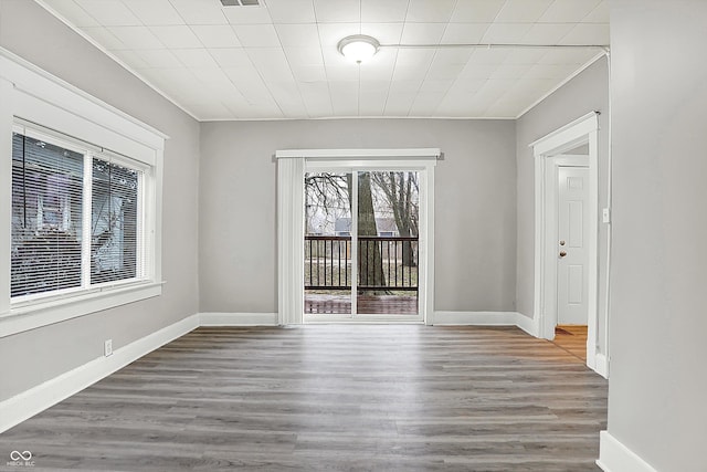 unfurnished dining area featuring ornamental molding and hardwood / wood-style floors