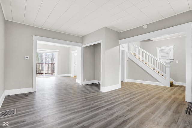 unfurnished living room featuring hardwood / wood-style flooring