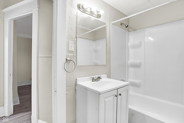 bathroom featuring vanity, wood-type flooring, and shower / bathing tub combination