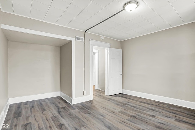 spare room with dark hardwood / wood-style floors