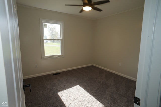 carpeted spare room featuring ornamental molding and ceiling fan