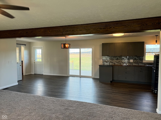 kitchen with dark wood-type flooring, decorative light fixtures, decorative backsplash, and plenty of natural light