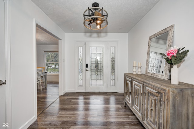 5909 Buttonwood Dr, Noblesville, IN 46062 - entrance foyer with a chandelier, a textured ceiling, wood finished floors, and baseboards