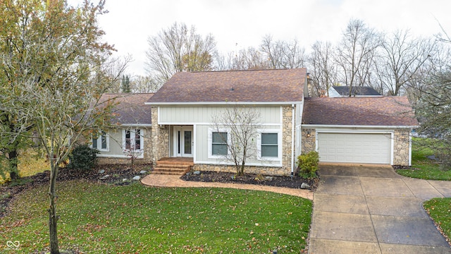 5909 Buttonwood Dr, Noblesville, IN 46062 - mid-century modern home featuring stone siding, driveway, an attached garage, a front lawn, and board and batten siding