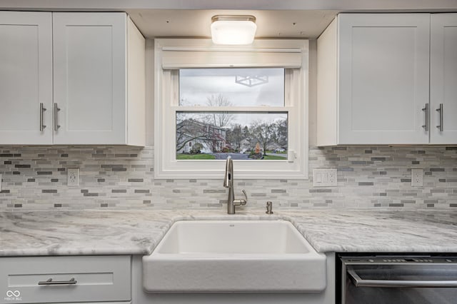 5909 Buttonwood Dr, Noblesville, IN 46062 - kitchen featuring stainless steel dishwasher, a sink, white cabinetry, and backsplash