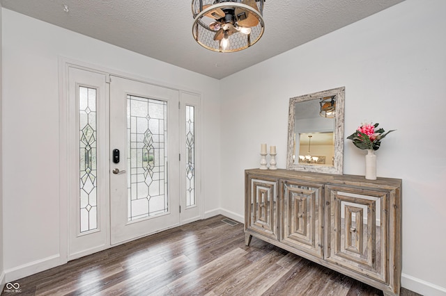 5909 Buttonwood Dr, Noblesville, IN 46062 - entrance foyer featuring a chandelier, wood finished floors, baseboards, and a textured ceiling